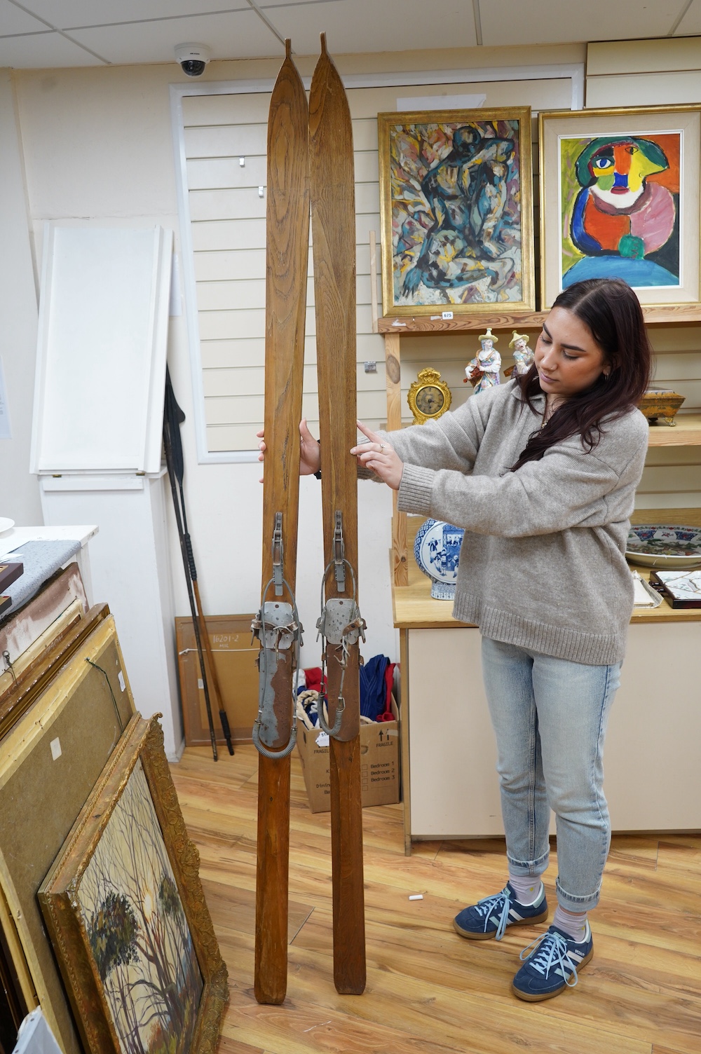 A pair of early 20th century wooden skis with Kandahar metal bindings. 207cm long. Condition - bindings rusty in places leather strapping worn in places, skis appear good but are untested